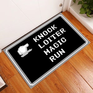 May include: Black and white doormat with the words "Knock, Loiter, Magic, Run" in a pixelated font. A white pixelated hand is in the top left corner.