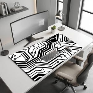 May include: A black and white computer mouse mat with a circuit board design. The rectangular mat features a repeating pattern of black lines and shapes on a white background. A keyboard and mouse sit on the mat, alongside a computer monitor.