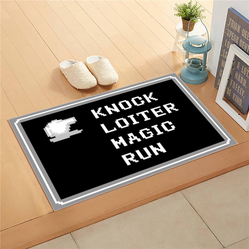 May include: Black and white doormat with the words "Knock", "Loiter", "Magic", and "Run" in a pixelated font.