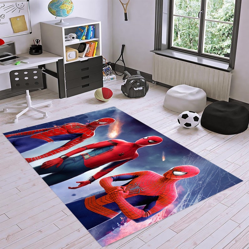 May include: A blue, red, and black rug with three Spider-Man characters on it. The rug has a blue background with red and white spider webs.