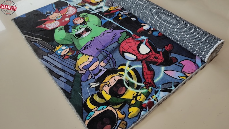 May include: A rolled-up rectangular rug with a vibrant comic book design showcasing superheroes like Spider-Man and Hulk. The rug has a dark blue backdrop, a grey border, and a non-slip backing. The design is a colourful illustration.