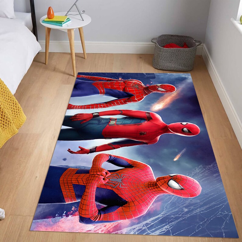 May include: A red and blue area rug with a design of three Spider-Man characters in different poses. The rug has a blue background with white streaks and red and orange flames.