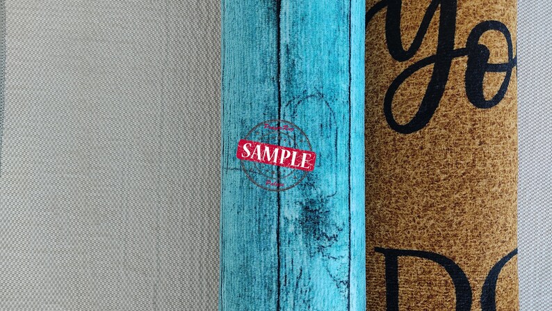 May include: Two doormats, one with a blue woodgrain pattern and the word "SAMPLE" in red, and the other with a brown background and the text "you do" in black.