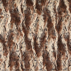 May include: A brown, gray, and white faux fur fabric with a wavy pattern.