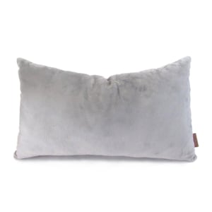 May include: A soft, gray, rectangular pillow with a plush, fuzzy texture.
