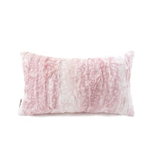 May include: A pink and white faux fur throw pillow with a soft, plush texture.