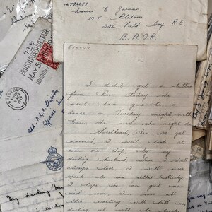 May include: A close-up of a handwritten letter with blue ink on lined paper. The letter is folded in half and the top portion is visible. The letter reads, "I didn't get a letter from Rose today, she went have gone to a dance on Tuesday night, with Eric; she said she might do married, I won't look at even one chof, only my darling husband, when I shall always love, I well never speak to one either, Micky, I hope we can get mar this soon, I'm sure all darling, waiting will kill us to wake up in the lovely and find your arms around me, I know we shall be"