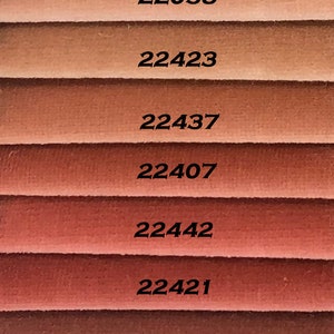 May include: Nine fabric swatches in various shades of brown, from light beige to dark brown. Each swatch has a number printed on it: 22111, 22058, 22423, 22437, 22407, 22442, 22421, 22703, 22408.