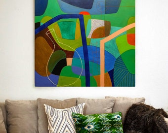 May include: Abstract painting with geometric shapes in shades of green, blue, brown, and pink. The painting is framed and hanging on a white wall above a couch with pillows.