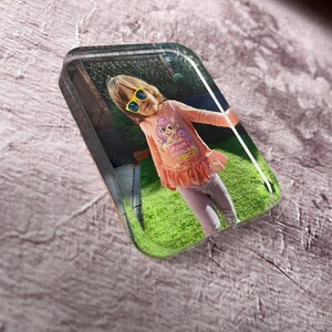 May include: A clear acrylic block with a photograph of a young person wearing yellow sunglasses and a pink top. The top has the text "Forever Fierce". The background shows a green lawn and a fence.