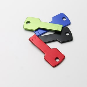 May include: Four key-shaped USB flash drives in different colours: green, blue, black and red.