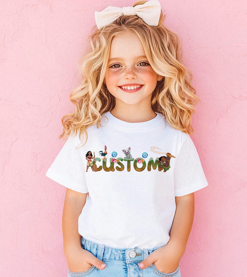 A young girl with curly blonde hair is smiling and wearing a white t-shirt with the word "CUSTOM" printed on it.