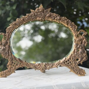 Antique Brass Cherub Dressing Mirror: Beveled Glass, Floral Frame, N.B.&I.W. C.1895-1910