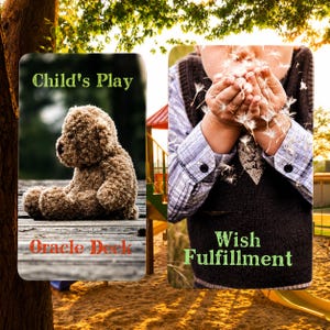 May include: Two rectangular oracle deck cards. The left card features a brown teddy bear sitting on wooden planks with the text Child's Play and Oracle Deck. The right card shows hands blowing dandelion seeds with the text Wish Fulfillment.
