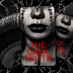 May include: A deck of rectangular cards featuring a black and white close-up of a face with dark lips and symbols on the skin. The text THE DARK TRUTH is printed in red across the lower portion of the cards, which are set against a shattered glass background.