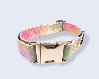 May include: A tie-dye dog collar with a silver buckle and a silver D-ring. The collar is made of a soft, durable fabric and is available in a variety of colors.