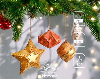 May include: Four hanging ornaments in gold, coral, and white, featuring stitched edges and geometric shapes including a star, diamond, and sphere. The image includes file format icons for DXF, SVG, and PDF, along with the text Nomade at the bottom.