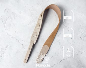 May include: A light beige leather guitar strap with adjustable loops and reinforced ends. The image includes three white icons labeled DXF, SVG, and PDF, along with a sunburst graphic and the text Nomade at the bottom of the strap.