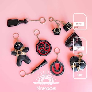 May include: A collection of black leather keychains with red stitching, including a paddle, cuffs, a gingerbread figure, a circular symbol, a spade, a tassel, a V-shaped emblem, and a heart with straps. Digital file icons labelled DXF, SVG, and PDF are visible.