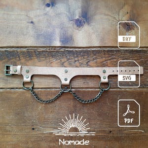 May include: A light tan leather strap featuring a metal buckle, three circular metal rings, and two dark metal chains connecting the rings. The image includes file icons labeled DXF, SVG, and PDF, along with the text Nomade at the bottom.