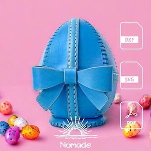 May include: A blue leather egg-shaped container with a decorative bow and stitched seams. The image includes file format icons labeled DXF, SVG, and PDF, along with the text Nomade and a sunrise graphic, surrounded by colorful speckled candies.