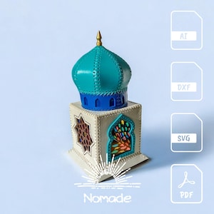 Könnte beinhalten: Ein weißes, blaues und grünes Papiermodell einer Moschee mit einem Kuppeldach. Das Modell steht auf einem weißen Hintergrund mit dem Wort "Nomade" darunter. Das Bild enthält auch Symbole für die Dateiformate AI, DXF, SVG und PDF.