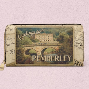 May include: A vintage-style postcard design zippered wallet with a picture of a house and bridge. The text on the postcard reads "Greetings from Pemberley".