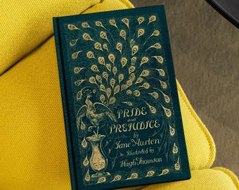 May include: A green hardcover book with a gold peacock design and the title "Pride and Prejudice" by Jane Austen, illustrated by Hugh Thomson.