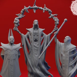 May include: Three gray painted figurines of figures in robes, one with a skeletal face and a ring of smoke above their head, one with a pointed head, and one with a normal face. The figures are standing on a red surface.