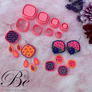May include: A set of pink polymer clay earring designs with geometric and watermelon patterns. The earrings are displayed on a pink surface with a set of pink plastic square cutters.