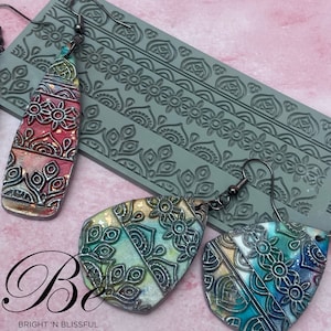 May include: A set of three silicone molds for making polymer clay earrings. The molds feature intricate mandala designs. The image also shows three pairs of earrings made with the molds, featuring colorful watercolor and metallic accents.