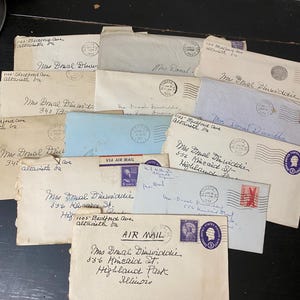 May include: A collection of vintage paper envelopes in various shades of white, cream, and light blue. Each envelope features handwritten addresses to Mrs. Donal Dinwiddie, postmarks, and United States postage stamps with various dates and markings.