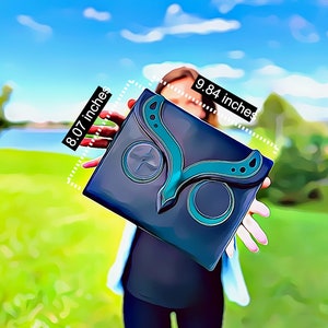 May include: A black clutch with a teal butterfly design. The clutch measures 25 cm by 20.5 cm.