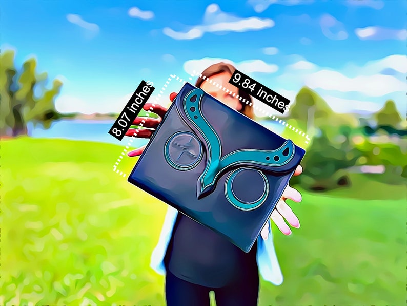 May include: A black clutch with a teal butterfly design. The clutch measures 25 cm by 20.5 cm.