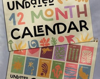 May include: Two spiral-bound, undated 12-month calendars. The top calendar displays the words "UNDATED 12 MONTH CALENDAR" in various colors. The bottom calendar shows monthly illustrations and the same text. The calendars have a beige background.