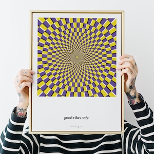 May include: A framed print with a yellow and purple optical illusion design. The print has the text "good vibes only." at the bottom.