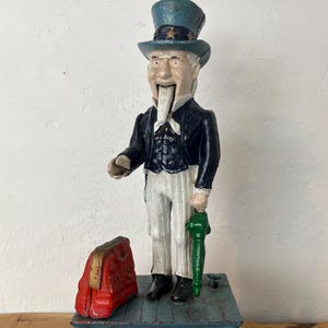 Cofrinho mecânico Tio Sam de ferro fundido vintage americano