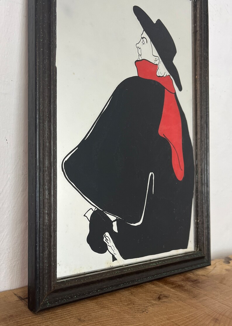 Stunning vintage wall art mirror featuring the famous cabaret star now in a gallery at San Diego Museum of Art, with vivid tones with wide brimmed hat and scarf creating a classic Lautrec art nouveau design.