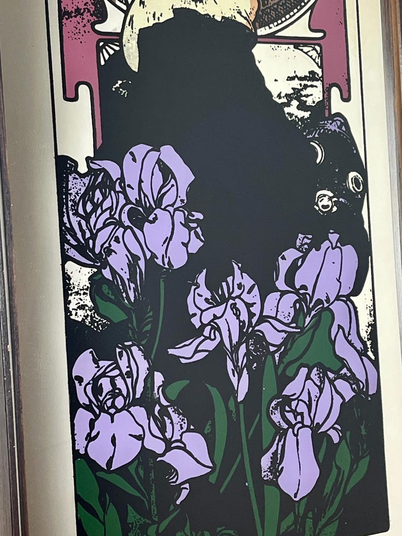 May include: Art Nouveau style print featuring lavender iris flowers with green leaves against a black background. The print has a white border and a decorative top section with a figure.