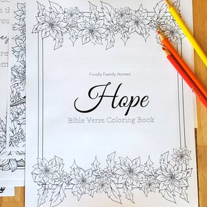 Front page of Hope Bible Verse Coloring Book from Finally Famly Homes with poinsettias framing it