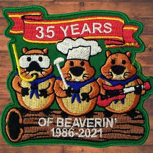May include: Embroidered patch with three cartoon beavers on a log. One wears a snorkel, another a chef's hat, and the third plays a guitar. The patch reads "35 YEARS OF BEAVERIN' 1986-2021" in red and white lettering.