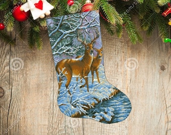 May include: A blue and white Christmas stocking with a winter scene featuring two deer in a snowy forest. The stocking is decorated with a white border and a red heart.
