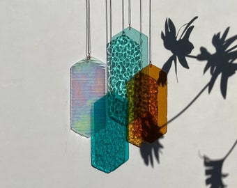 Mobile with geometric glass, window installation, modern glass art sun catcher play of light with luminous elements