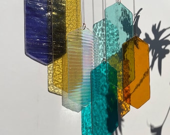 Mobile with geometric glass, window installation, modern glass art sun catcher play of light with luminous elements
