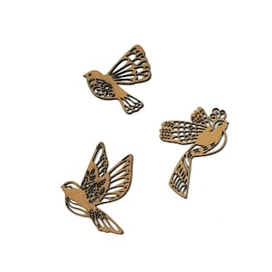 May include: Three brown wooden bird cutouts with intricate designs. The birds are in flight and have detailed wings and feathers.