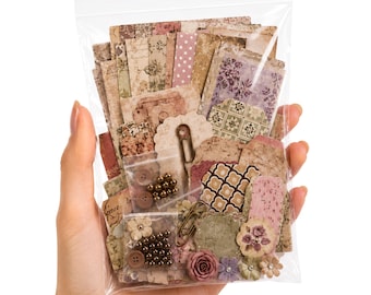 May include: A clear plastic bag filled with assorted paper ephemera, including rectangular and scalloped tags with vintage floral, polka dot, and geometric patterns. The set contains small metal paper clips, brown buttons, and metallic beads.