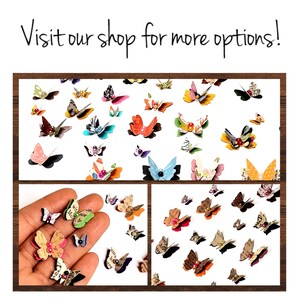 May include: Assortment of colorful paper butterflies with various patterns and embellishments. The butterflies are scattered on a white background. Some butterflies have beads or sequins for decoration.
