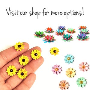 May include: Assortment of paper flowers in various colors, including yellow, pink, blue, green, and purple. The flowers are arranged in a hand and on a white background. Visit our shop for more options!