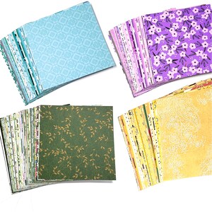 May include: A set of 100 sheets of patterned origami paper. The paper is in a variety of colors and patterns, including green, blue, purple, and yellow. The paper is folded into squares and stacked in piles.
