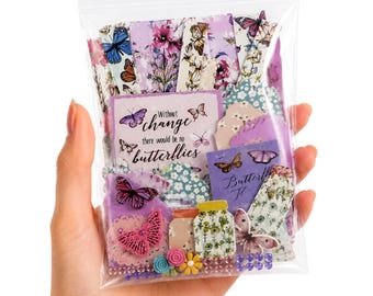 May include: A clear plastic bag filled with assorted paper ephemera featuring butterfly and floral designs in shades of purple, pink, and blue. The collection includes rectangular cards with the text "Without change there would be no butterflies."
